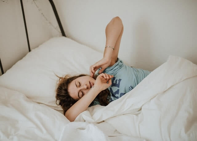 Want to be like this girl sleeping comfortably in bed? It’s possible. All you have to do is understand the right way to improve your sleep hygiene.